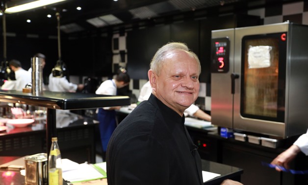 FILE- In this file photo taken on December 06, 2014 French cook Joel Robuchon is pictured in Bordeaux, southwestern France, in the kitchen of "La Grande maison", a first class restaurant born from his association with wine producer Bernard Magrez. AFP / N