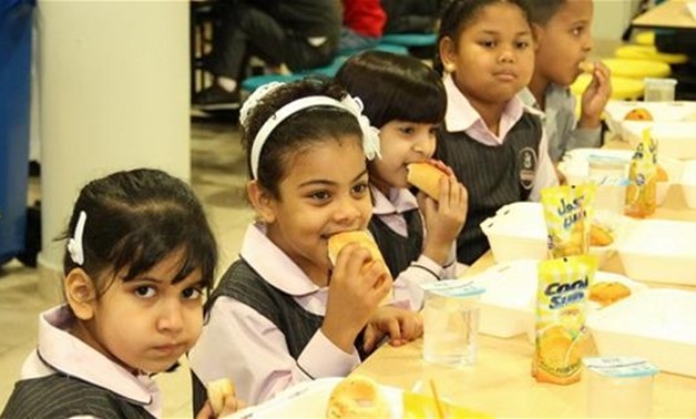 FILE - Children earing school meals