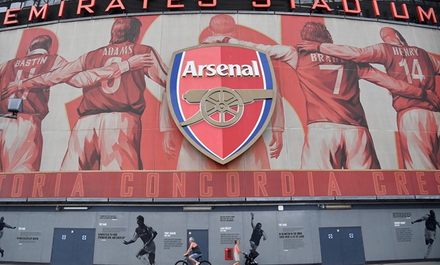 People walk and cycle past Emirates Stadium, the home of Arsenal soccer club in London, Britain, August 7, 2018. REUTERS/Toby Melville
