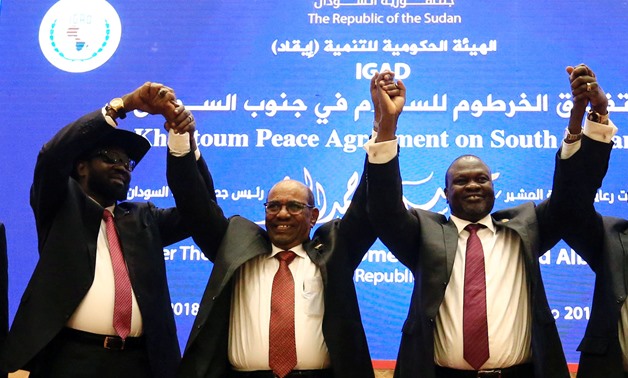 FILE - South Sudan President Salva Kiir (L), Sudan's President Omar Al-Bashir (C) and South Sudan rebel leader Riek Machar hold hands after signing a peace agreement aimed to end a war in which tens of thousands of people have been killed, in Khartoum, Su