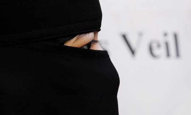 FILE PHOTO: A Muslim woman takes part in a demonstration outside the French Embassy in London September 25, 2010. REUTERS/Luke MacGregor