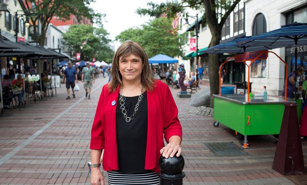 Vermont Democratic Party gubernatorial primary candidate Christine Hallquist, a transgender woman, poses as she campaigns on Church Street in Burlington, Vermont, U.S., August 8, 2018. Picture taken August 8, 2018. REUTERS/Caleb Kenna
