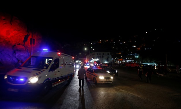 An ambulance and a Jordanian police car is seen one day after the security incident, at the city of Al Salt, Jordan, August 11, 2018. REUTERS/Muhammad Hamed
