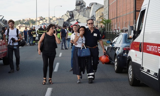 Firefighters searched into the night on Tuesday for survivors and bodies amid the rubble of a motorway bridge that collapsed in the northern Italian port city of Genoa.