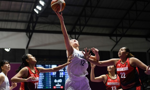 North Korean Ro Suk Yong (C), a member of the Unified Korea basketball team at the Asian Games, top-scored with 22 points, helping her team smash their hosts Indonesia - AFP / Anthony WALLACE