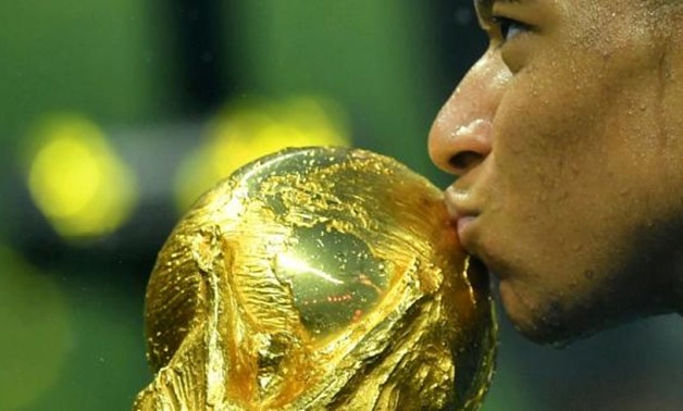 FILE PHOTO: Soccer Football - World Cup - Final - France v Croatia - Luzhniki Stadium, Moscow, Russia - July 15, 2018 France's Kylian Mbappe kisses the trophy as he celebrates winning the World Cup REUTERS/Dylan Martinez
