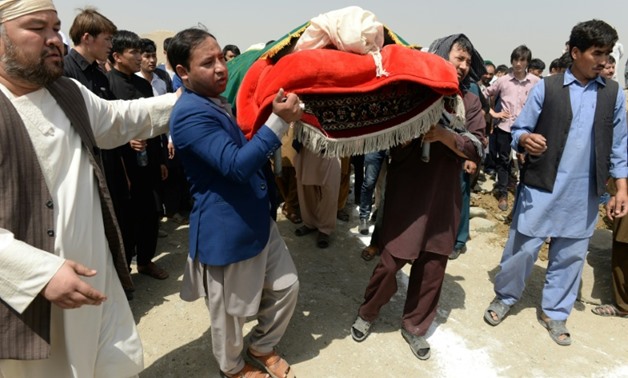Afghan Shiite mourners buried the dead on Thursday from a suicide attack on an education centre the day before, even as gunmen launched another attack in war-weary Kabul
