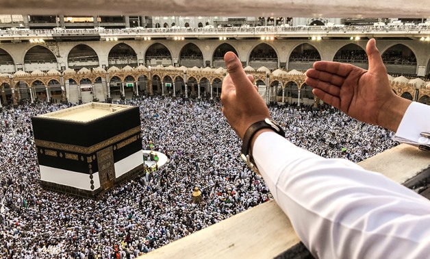 A muslim pilgrim prays while others circle the Kaaba and pray at the Grand mosque ahead of annual Haj pilgrimage in the holy city of Mecca, Saudi Arabia August 16, 2018.REUTERS/Zohra Bensemra