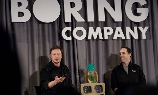 Elon Musk, left, won the bidding to build a high-speed link between the Loop and O'Hare.

