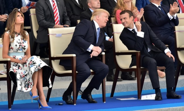 US President Donald Trump (2nd L) decided he wanted a large military parade in Washington after taking in the Bastille Day parade in Paris with French President Emmanuel Macron (2nd R) in 2017
