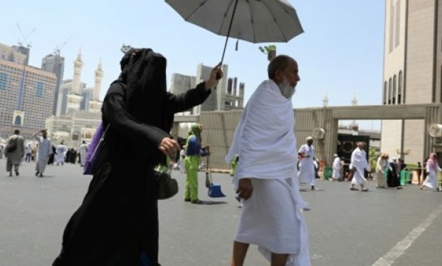 © AFP | Muslims walk in Saudi Arabia's holy city of Mecca on August 18, 2018, ahead of the start of the annual hajj pilgrimage