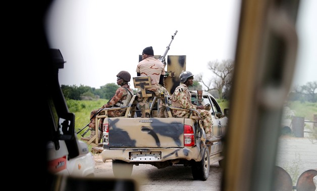 FILE PHOTO: A Nigerian army convoy vehicle drives ahead with an anti-aircraft gun, on its way to Bama, Borno State, Nigeria August 31, 2016. Picture taken from inside a vehicle. REUTERS/Afolabi Sotunde/File Photo
