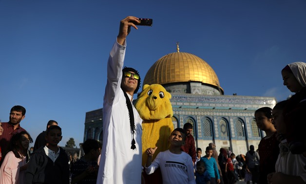 A Palestinian man takes a selfie following morning prayers marking the first day of Eid al-Adha celebrations, on the compound known to Muslims as al-Haram al-Sharif and to Jews as Temple Mount in Jerusalem's Old City August 21, 2018 REUTERS/Ammar Awad