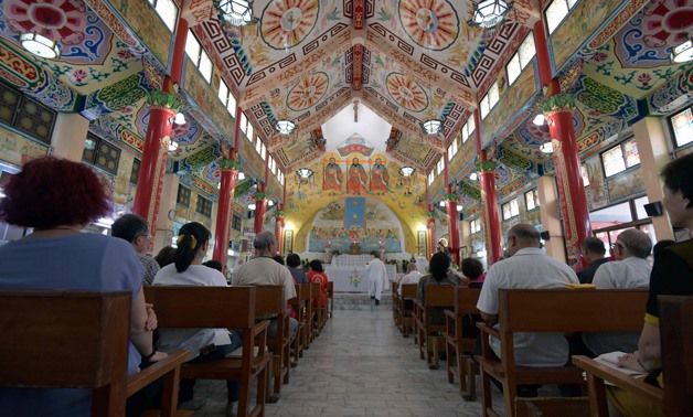 This picture taken on August 10, 2018 shows worshippers attending mass in the Holy Spirit Church in Yanshui, about an hour's drive from the southern city of Tainan- / AFP / Sam YEH