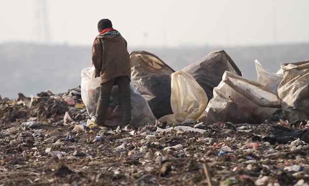 File- A street child collects garbage in Katamyia district- Cairo/Egypt Today/Maher Iskander