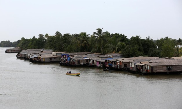A motorboat moves past a row of empty houseboats in a tributary of the Pamba river following floods in Alappuzha district in the southern state of Kerala, India, August 24, 2018. REUTERS/Sivaram V