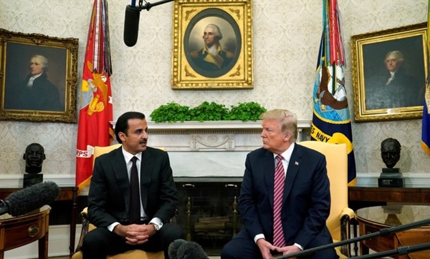 U.S. President Donald Trump meets Qatar's Emir Sheikh Tamim bin Hamad al-Thani in the Oval Office at the White House in Washington. U.S., April 10, 2018. REUTERS/Kevin Lamarque Via REUTERS