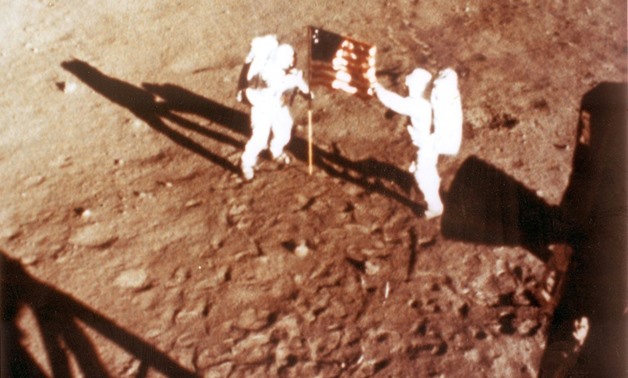 NASA photo taken on July 20, 1969 shows US astronauts Neil Armstrong and "Buzz" Aldrin deploying the US flag on the lunar surface during the Apollo 11 mission.