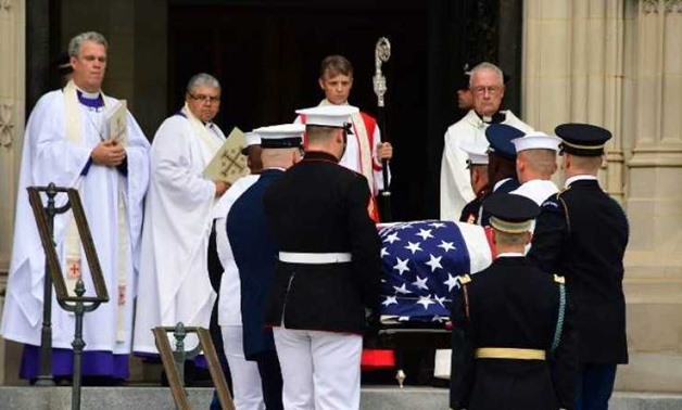 A military honor guard team carries the casket of late Senator John McCain (R-AZ) as it arrives at the Washington Cathedral for a religious service on September 1, 2018 in Washington, DC. (Photo | AFP)