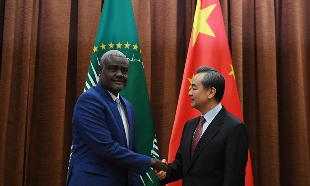 African Union Commission Chairperson Moussa Faki Mahamat (L) shakes hands with Chinese Foreign Minister Wang Yi before a meeting in Beijing, China February 8, 2018. REUTERS/Greg Baker/Pool