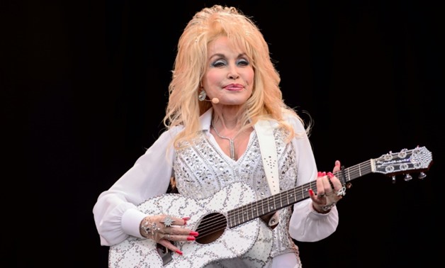 In this file photo taken in 2014, Dolly Parton performs on the Pyramid Stage in Somerset, England-AFP/File / LEON NEAL

