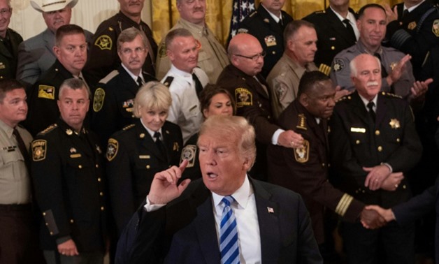 US President Donald Trump, seen here at a White House event with sheriffs from around the country, has lashed out at the author of bombsheld Op-ed piece that told of "quiet resistance" to him within the White House
