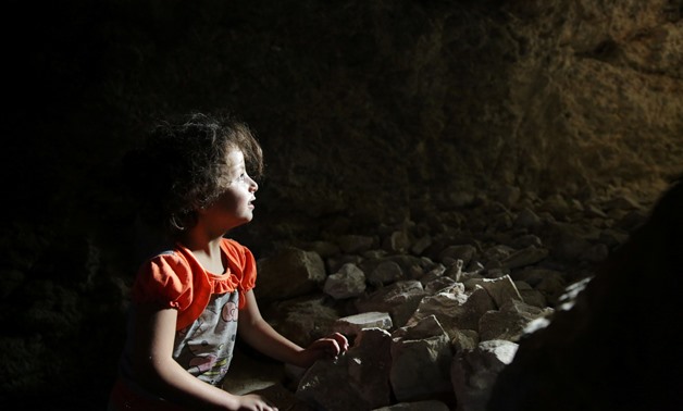 A girl is seen at a makeshift shelter in an underground cave in Idlib, Syria September 3, 2018. Picture taken September 3, 2018. REUTERS/Khalil Ashawi