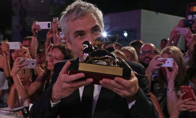 The 75th Venice International Film Festival - Awards Ceremony - Venice, Italy, September 8, 2018 - Director Alfonso Cuaron poses with the Golden Lion for Best Film. REUTERS/Tony Gentile.