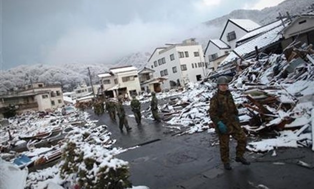 Members of the Japan Self Defence force walk through the snow-covered ruins of Kamaishi, Iwate Prefecture, days after the area was devastated by a magnitude 9.0 earthquake and tsunami March 16, 2011. REUTERS/Damir Sagolj

