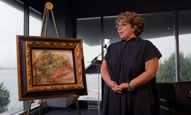 A Pierre Auguste Renoir painting "Femmes Dans Un Jardin," stolen by the Nazis, has been returned to the heir of its rightful owner, Sylvie Sulitzer, seen here at a ceremony at the Museum of Jewish Heritage in New York-AFP / TIMOTHY A. CLARY

