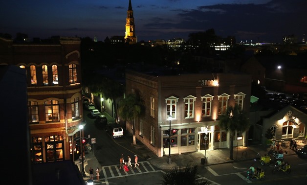 Tourists walk through the historic district on July 15, 2015 in Charleston, South Carolina. The second largest city in South Carolina, Charleston is known for its well-preserved architecture and was named 'America's Most Friendly City' in 2014 by Conde Na