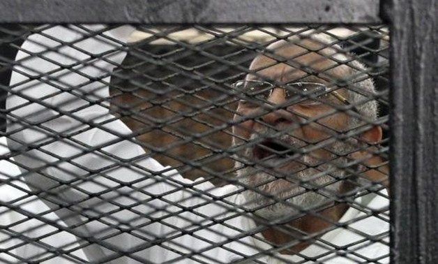 Muslim Brotherhood leader Mohammed Badie shouts slogans from the defendant’s cage during his trial with other leaders of the Brotherhood in a courtroom in Cairo December 11, 2013. Credit: Reuters/Stringer
