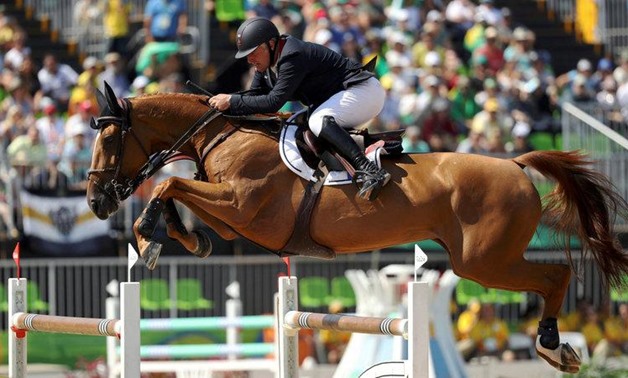 2016 Rio Olympics - Equestrian - Final - Jumping Team Finals - Olympic Equestrian Centre - Rio de Janeiro, Brazil - 17082016. Roger-Yves Bost (FRA) of France riding Sydney Une Prince jumps - REUTERS/Damir Sago