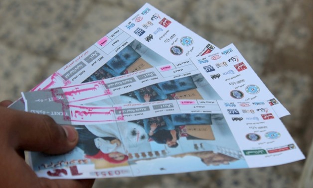A Yemeni man shows tickets for the movie "10 Days Before the Wedding" in front of a makeshift cinema in the southern city of Aden on September 13, 2018.