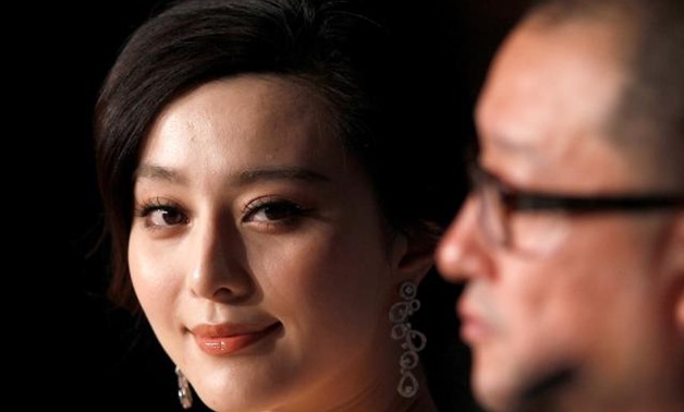 FILE PHOTO: Director Wang Xiaoshuai (R) and cast member Fan Bingbing attend a news conference for the film "Rizhao Chongqing" at the 63rd Cannes Film Festival, France May 13, 2010. REUTERS/Yves Herman/File Photo.