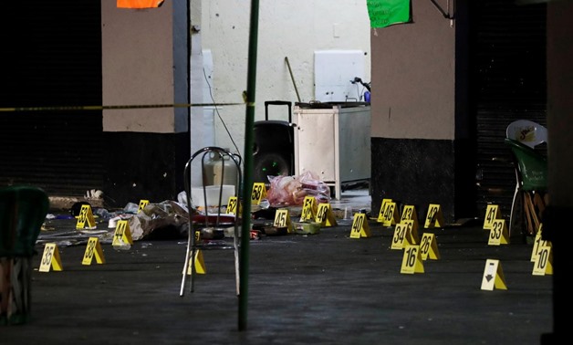 Evidence markers are seen at a crime scene where three men were gunned down by unknown assailants at an intersection on the edge of tourist Plaza Garibaldi in Mexico City, Mexico September 14, 2018. REUTERS/Henry Romero
