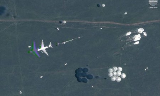 A satellite image shows an airborne paradrop in progress during the Russian military exercise known as Vostok 2018, conducted at the Tsugol training area in eastern Russia, September 13, 2018. Satellite image ©2018 DigitalGlobe, a Maxar company/Handout vi
