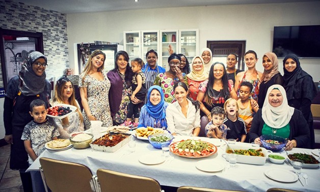 Britain's Meghan, Duchess of Sussex, cooks with women in the Hubb Community Kitchen at the Al Manaar Muslim Cultural Heritage Centre in the aftermath of the Grenfell Tower fire, which has resulted in the publications of 'Together: Our Community Cookbook' 
