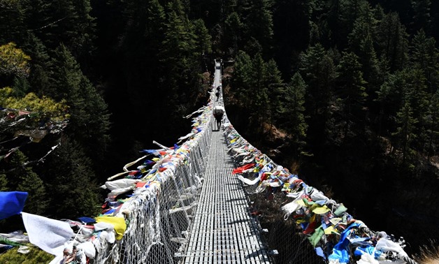 Nepali porters cross a suspension bridge to Namche Bazar, April, 2018.
 (AFP / Prakash Mathema)