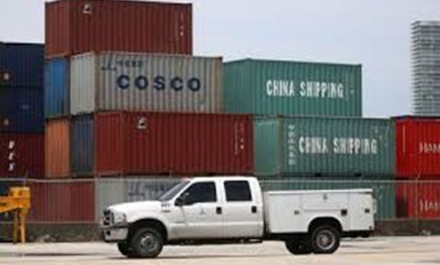 FILE PHOTO: A truck drives past Cosco and China Shipping shipping containers in the Port of Miami in Miami, Florida, U.S., May 19, 2016. REUTERS/Carlo Allegri/File Photo
