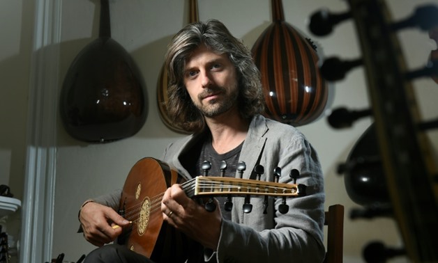 Belgian musician Tristan Driessens is one of the West's few masters of the oud, the oriental lute, and now works with refugees to preserve and develop their musical culture in their new host country-AFP / JOHN THYS

