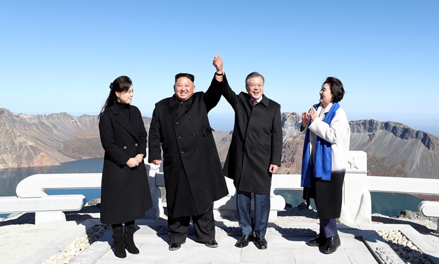 South Korean President Moon Jae-in and North Korean leader Kim Jong Un pose for photographs on the top of Mt. Paektu, North Korea September 20, 2018. Pyeongyang Press Corps/Pool via REUTERS TPX IMAGES OF THE DAY
