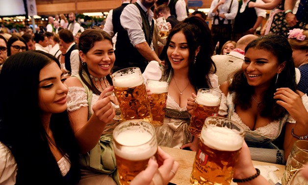 Thousands of visitors, many of them dressed in traditional lederhosen or dirndl corseted dresses, descended on Munich on Saturday for the start of the annual Oktoberfest, the world's largest beer festival - Reuters