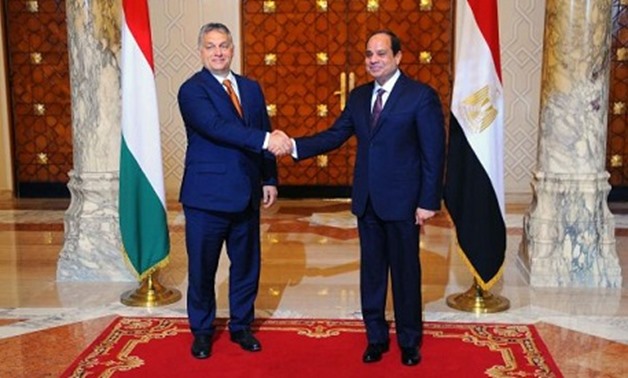 A handout picture released by the Egyptian Presidency shows Egyptian President Abdel Fattah El-Sisi (R) shaking hands with Hungarian Prime Minister Viktor Orban at the Presidential Palace in Cairo on June 1, 2016.