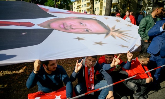 As well as protesters, wellwishers took to the streets of Cologne holding a huge portait of the Turkish president as he arrived to open one of Europe's largest mosques
