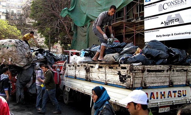 garbage bags are loaded on to trucks for disposal or recycling behind the Omar Makram Mosque in Tahrir Square, February, 12, 2011 – Wikimedia/Sherif2982
