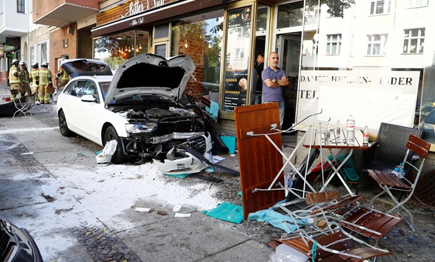 Firefighters look at damage after a man drove a car into a cafe in the Charlottenburg district of Berlin, Germany, October 5, 2018, injuring several people. REUTERS/Pawel Kopczinsky