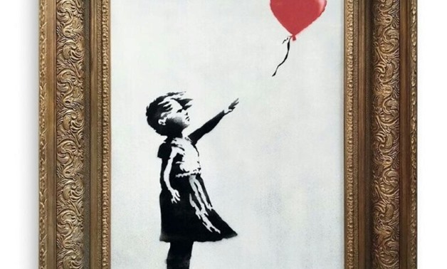 A pre-sale photo supplied by Sotheby's in London on October 6, 2018 shows "Girl with Balloon" by the British artist Banksy, which sold on October 5 for £1,042,000 and then unexpectedly passed through a shredder hidden in the frame.