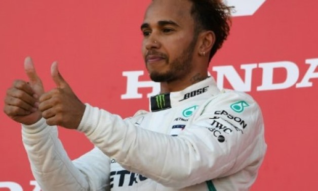 © AFP | Mercedes' British driver Lewis Hamilton celebrates on the podium after his victory in the Formula One Japanese Grand Prix at Suzuka on October 7, 2018.
