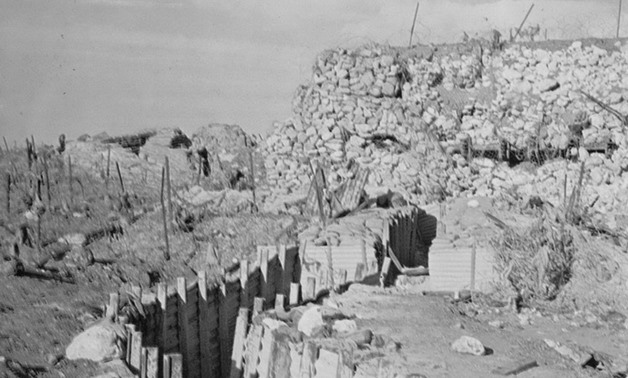 A trench in one of the fortifications of the Bar Lev Line, with a bunker in the background - CC